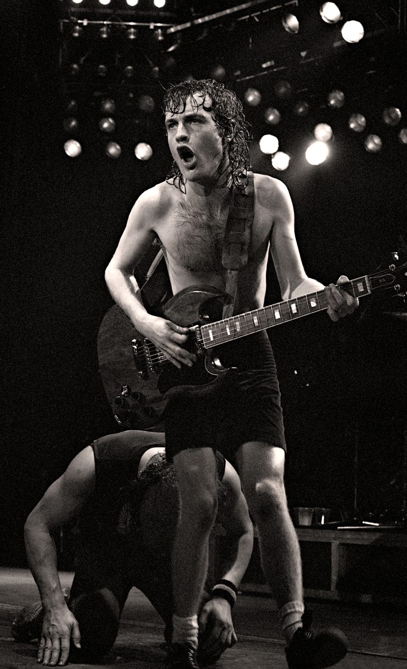 Angus Young with his Gibson SG on stage at the Manchester Apollo, England, 1982.