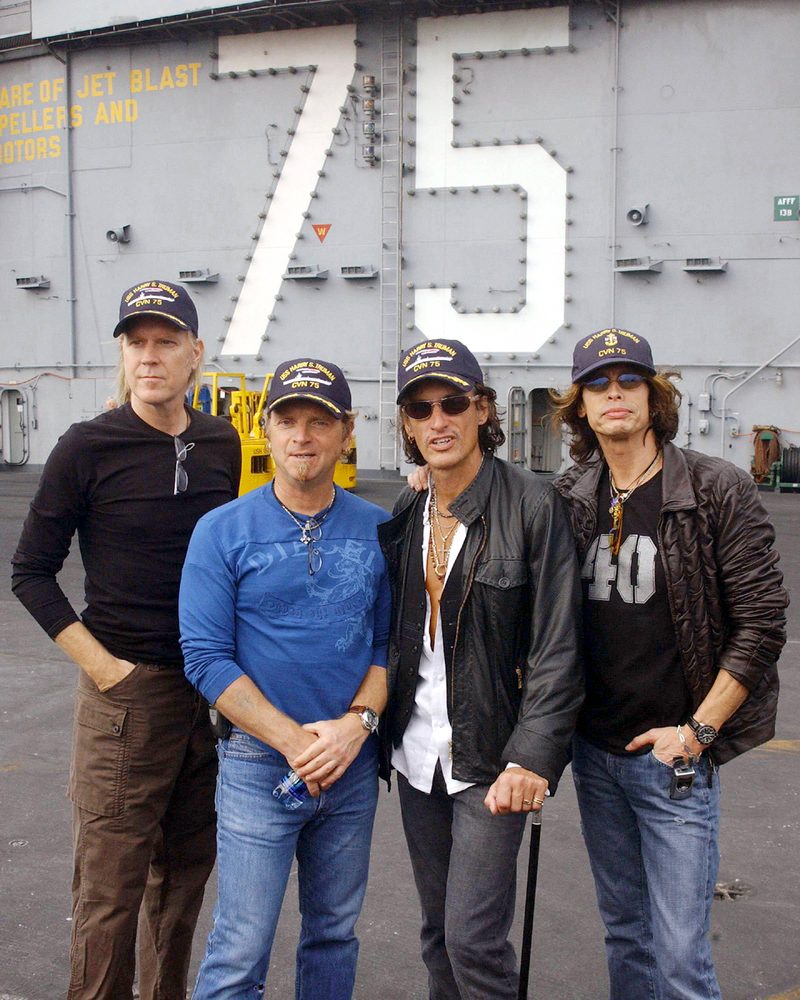 Tom Hamilton, Joey Kramer, Joe Perry and Steven Tyler (left to right) aboard the aircraft carrier USS Harry S. Truman at Norfolk, Virginia, 9 October 2002.