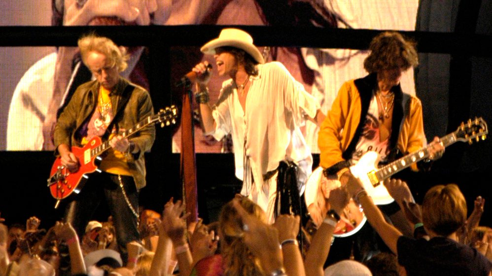 Brad Whitford, Steven Tyler and Joe Perry (left to right) playing the NFL Kickoff concert on the National Mall, Washington, D.C., 4 September 2003.