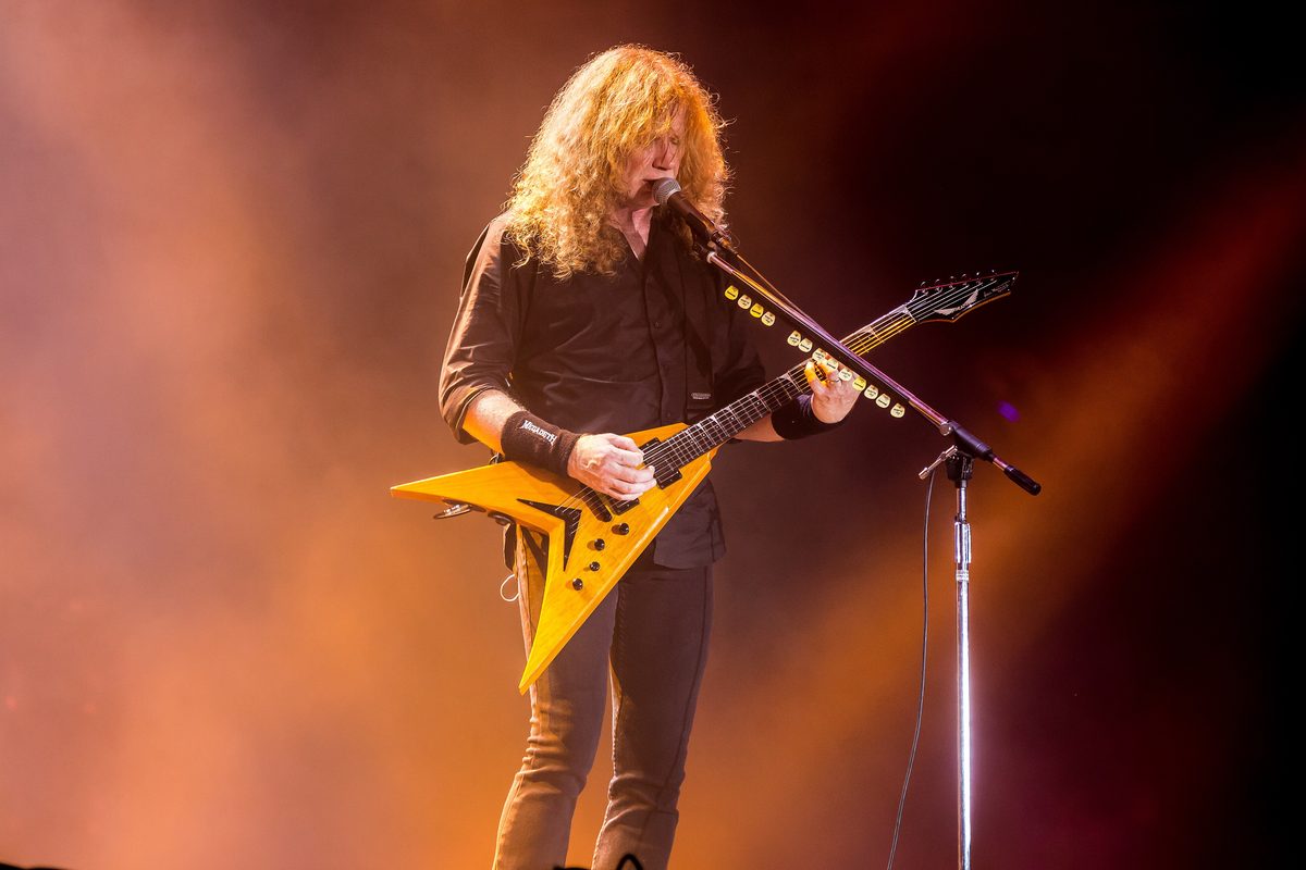 Dave Mustaine singing and playing a yellow V-shaped guitar with Megadeth at the Summer Breeze Open Air festival in Dinkelsbühl, Germany, on 17 August 2017.
