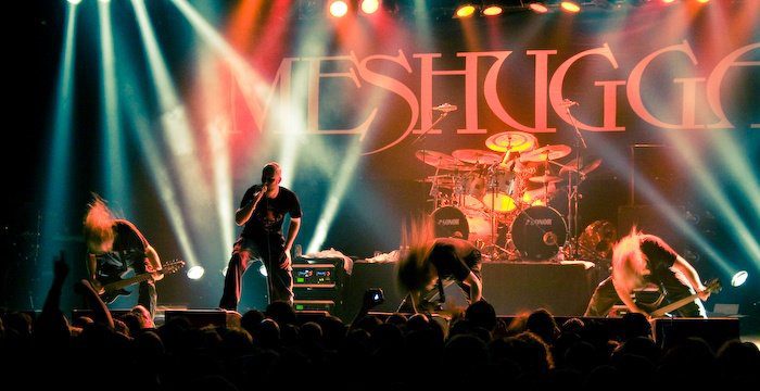 Meshuggah on stage under their MESHUGGAH backdrop in Melbourne on 15 October 2008, on the obZen tour, with Jens Kidman at the mic, Tomas Haake on drums and the three string players headbanging.