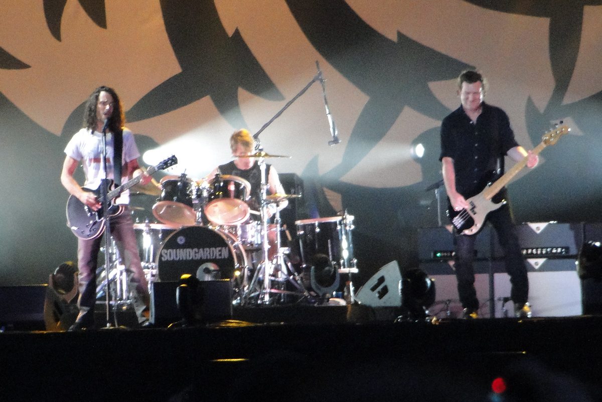 Soundgarden under their logo backdrop at Lollapalooza in Chicago on 8 August 2010: Chris Cornell on guitar, Matt Cameron behind the SOUNDGARDEN bass drum and Ben Shepherd on bass.