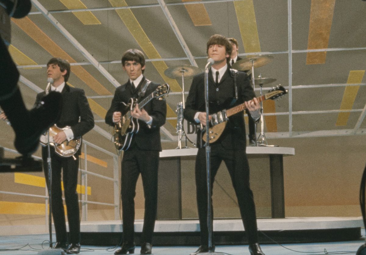 Paul McCartney, George Harrison and John Lennon, with Ringo Starr behind them, playing on The Ed Sullivan Show in New York, February 1964.