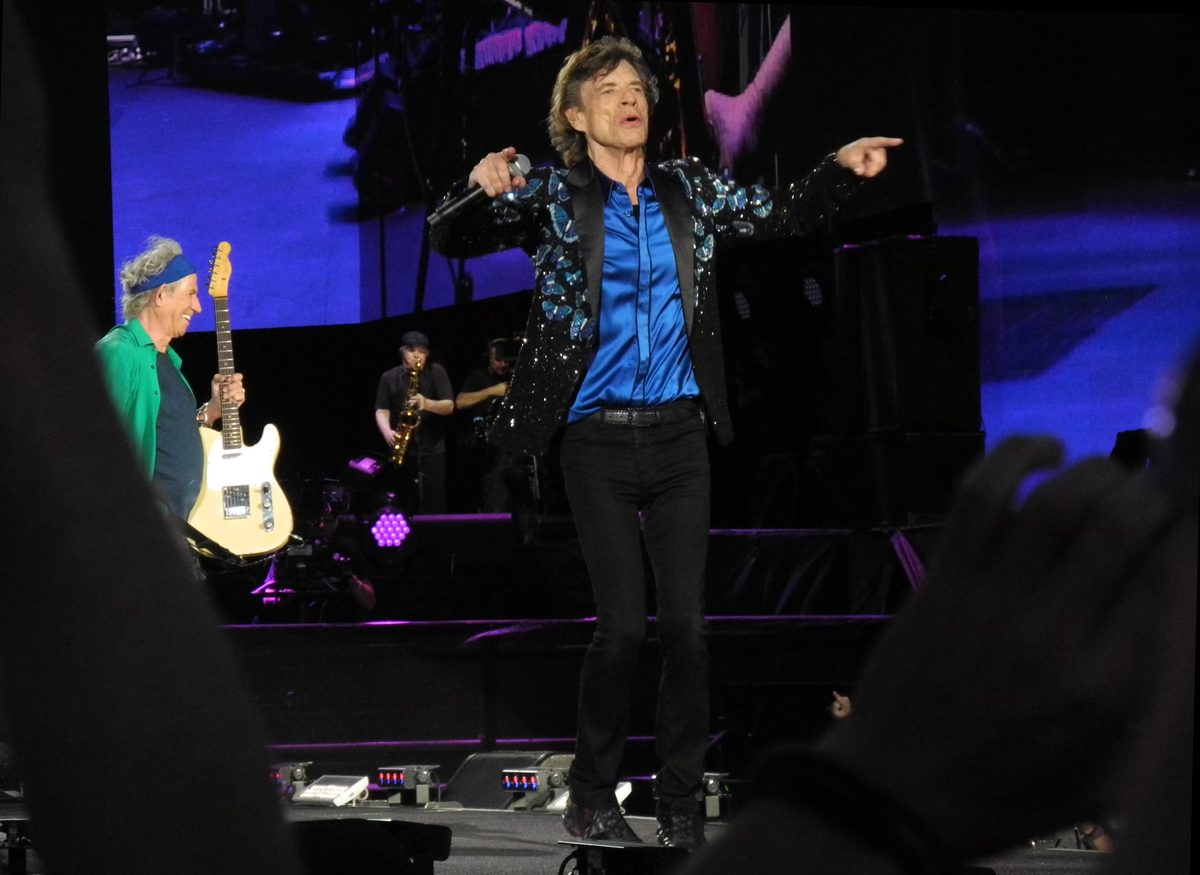 Mick Jagger singing at the front of the stage in Hyde Park, London, on 13 July 2013, with Keith Richards and his Telecaster on the left.